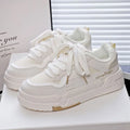 Children's beige height increasing trainers with thick rubber sole, lace-up front, and cross shoulder straps.