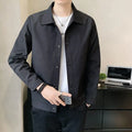 Man wearing a thin, single-layer Korean-style jacket in light grey, showcasing long sleeves and a casual fit.