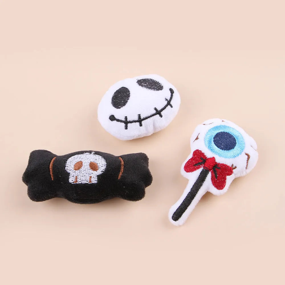 Plush cat teaser toy with long wand handle showing candy and skull designs