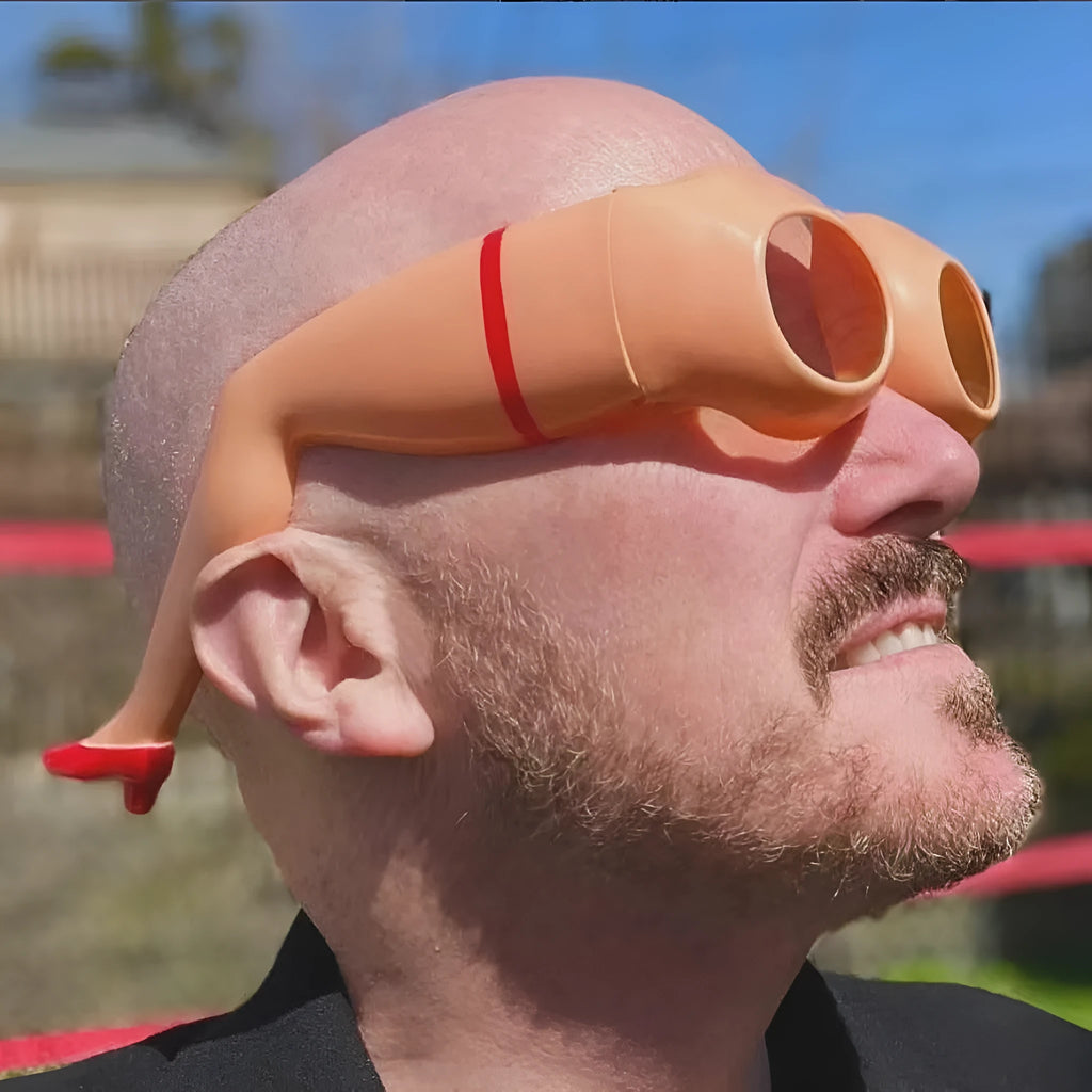 Orange novelty sunglasses with a leg and hip design theme and large rectangular lenses.