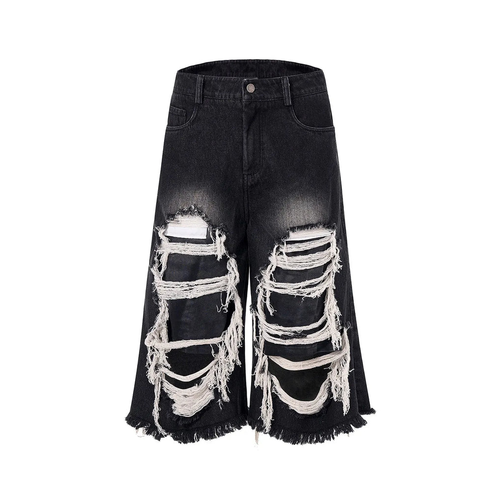 Black wide-leg cropped jeans with ripped patch detailing and mid-high waist