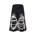 Black wide-leg cropped jeans with ripped patch detailing and mid-high waist