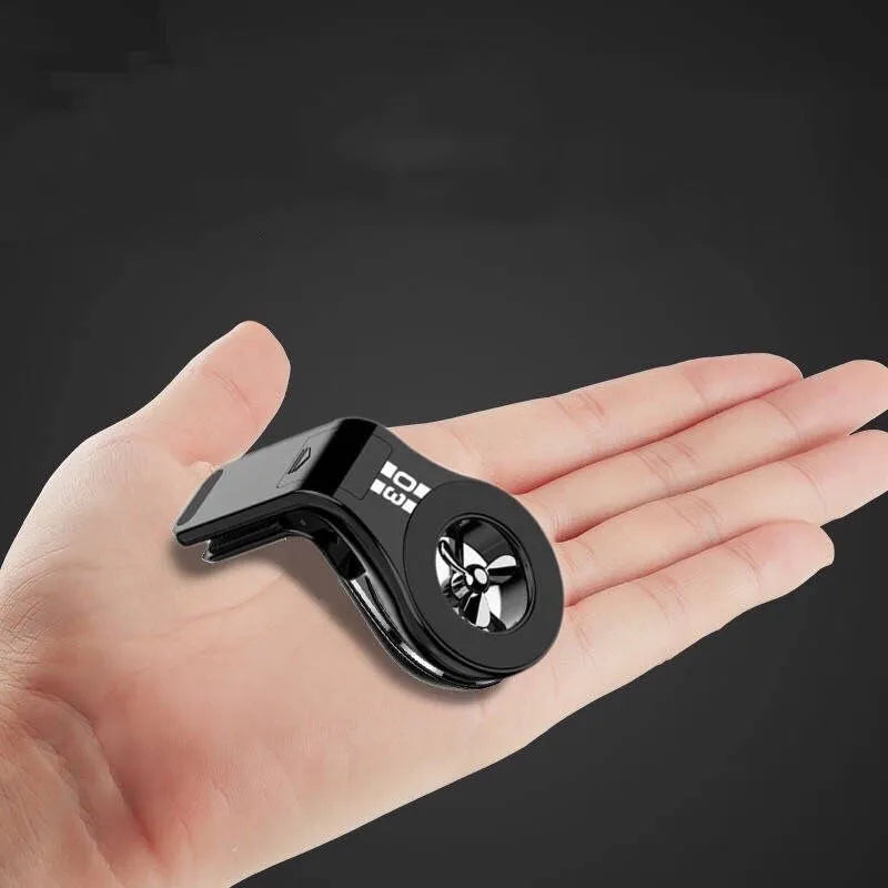 Black magnetic car phone holder attached to car air vent with phone mounted and adjustable rotation