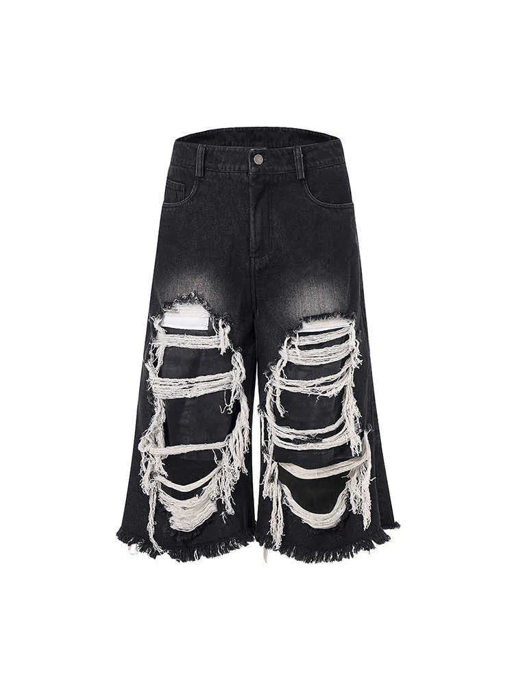 Black wide-leg cropped jeans with ripped patch detailing and mid-high waist