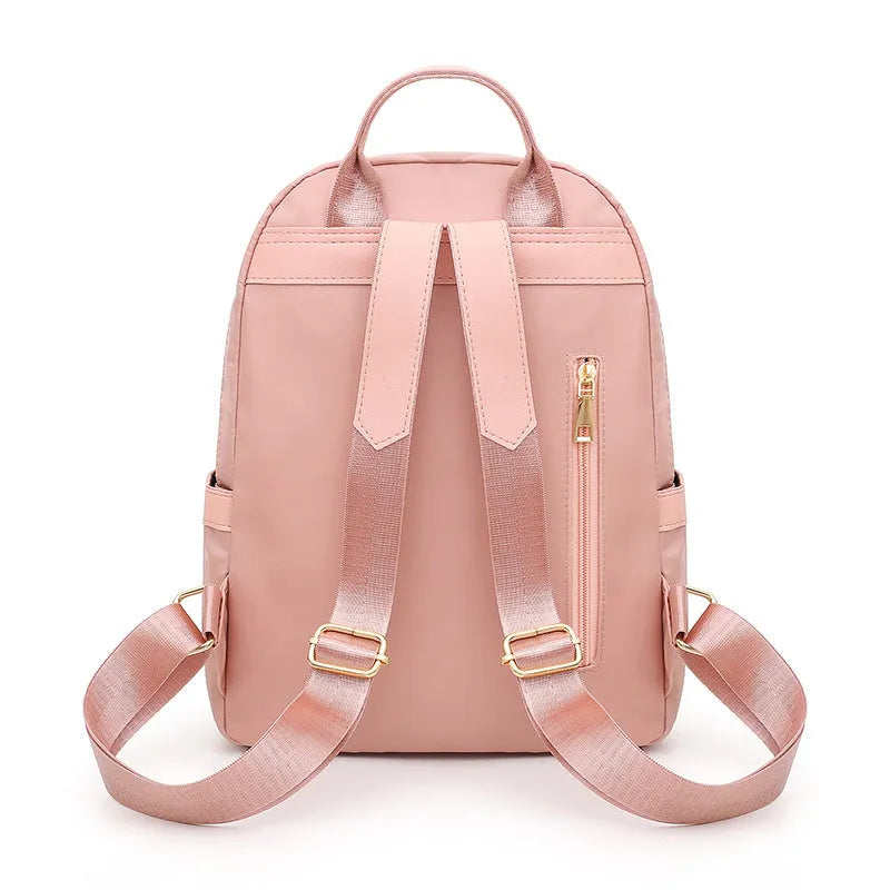 Black women's casual nylon backpack with soft handle and shoulder straps showing internal compartments