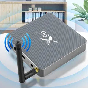Android smart TV set-top box with remote control, HDMI cable, and power adapter on a table.