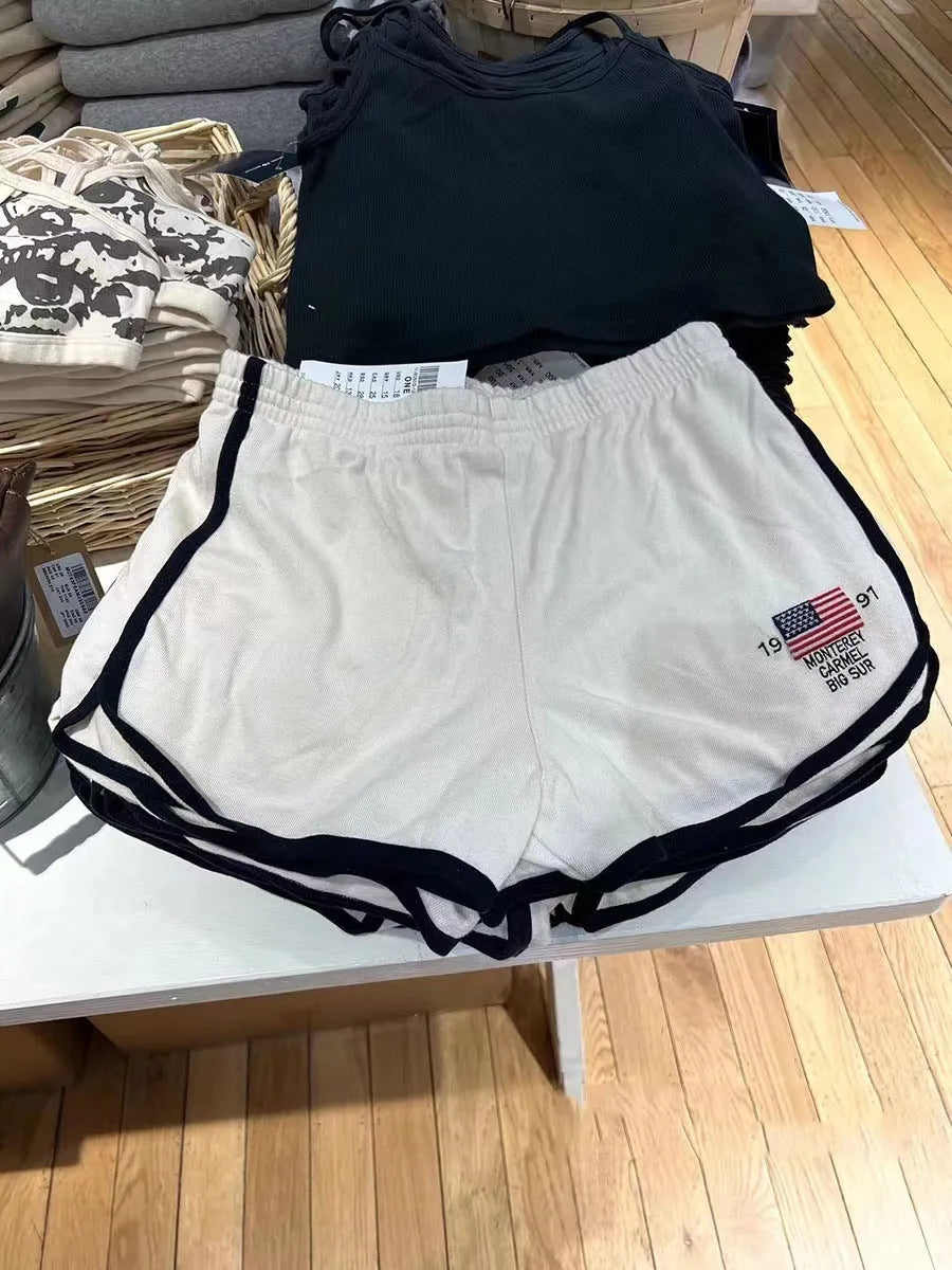 Women's dark blue cotton sports shorts with white flag embroidery, mid-thigh length athletic wear