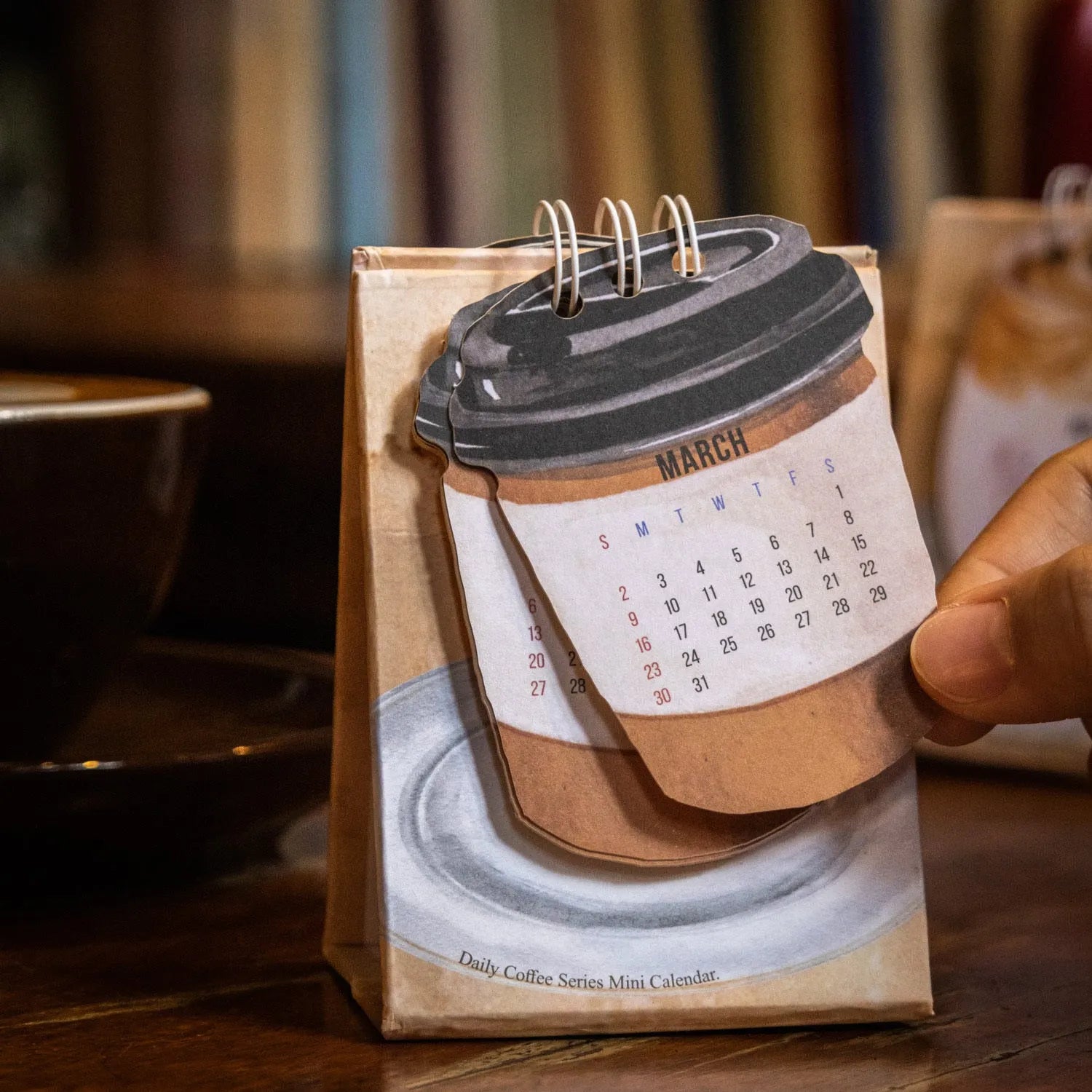 A5 size 2025 mini desk calendar open to a page showing a date and motivational quote.