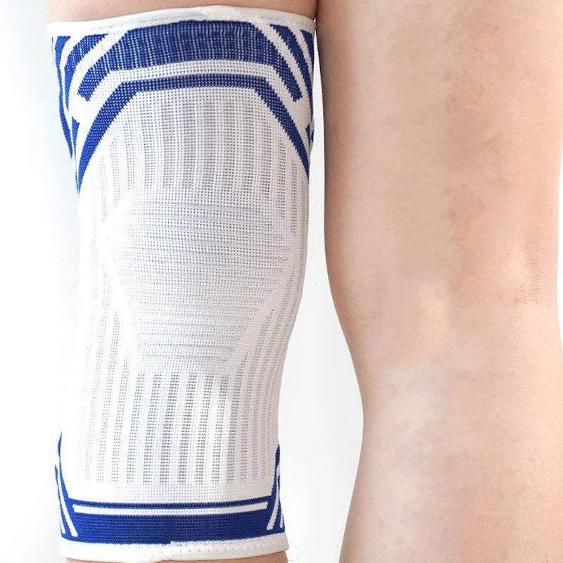 Adult elastic cotton knee pad for sports in blue, shown on a knee.