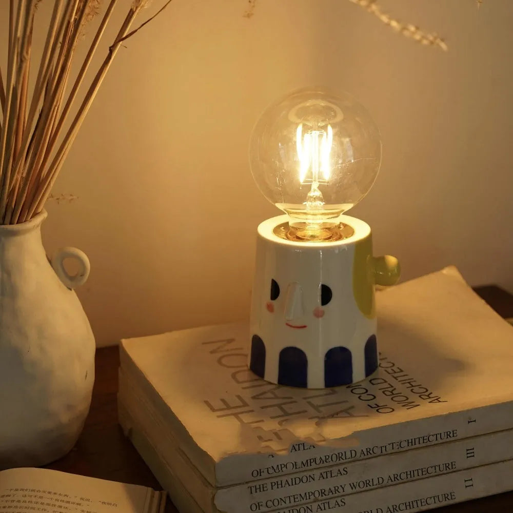 Handmade ceramic bedside lamp with spherical ball headlight shade on wooden nightstand