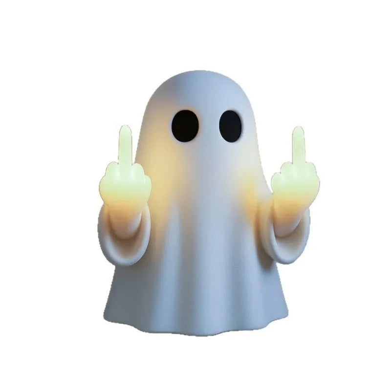 White plastic ghost night lamp with light on, on a flat surface