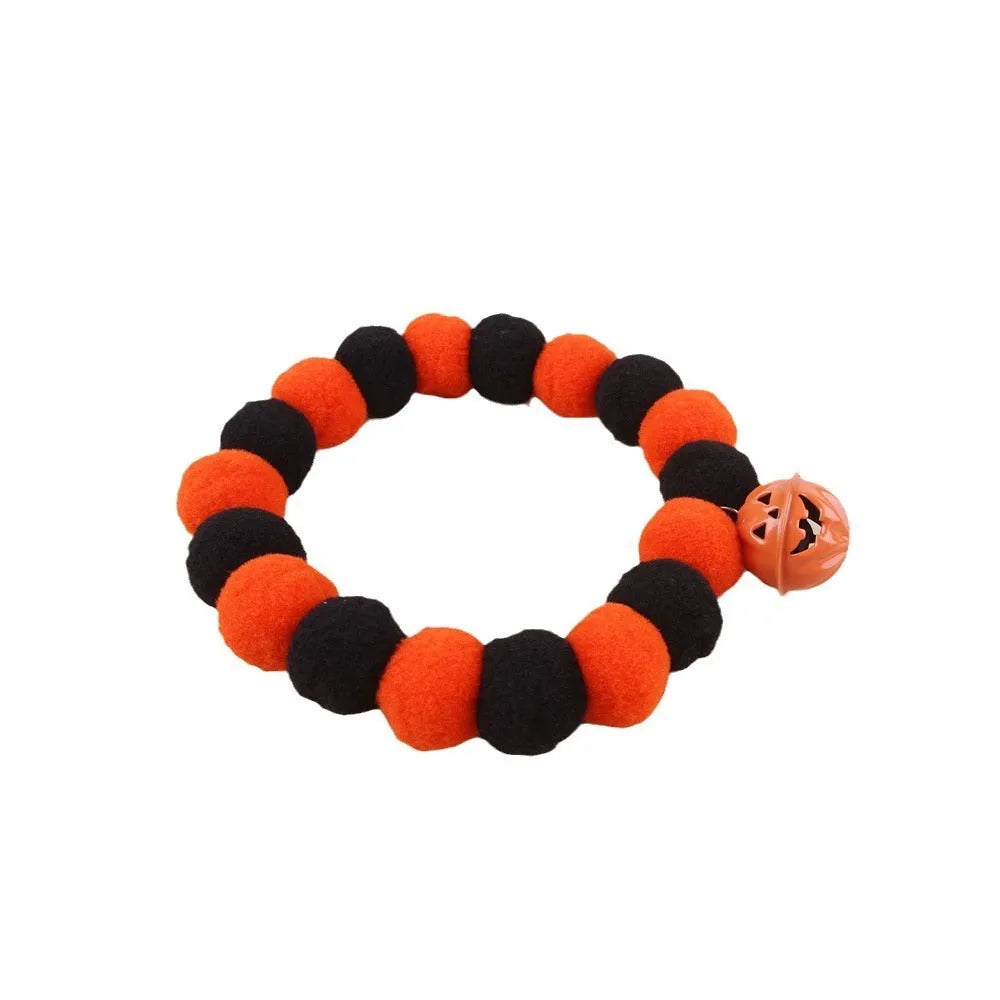Funny orange pumpkin design cat collar with black details and an adjustable plastic buckle.