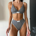 Women's black bikini set with white embroidered contrast binding letters on sleeveless top and shorts.