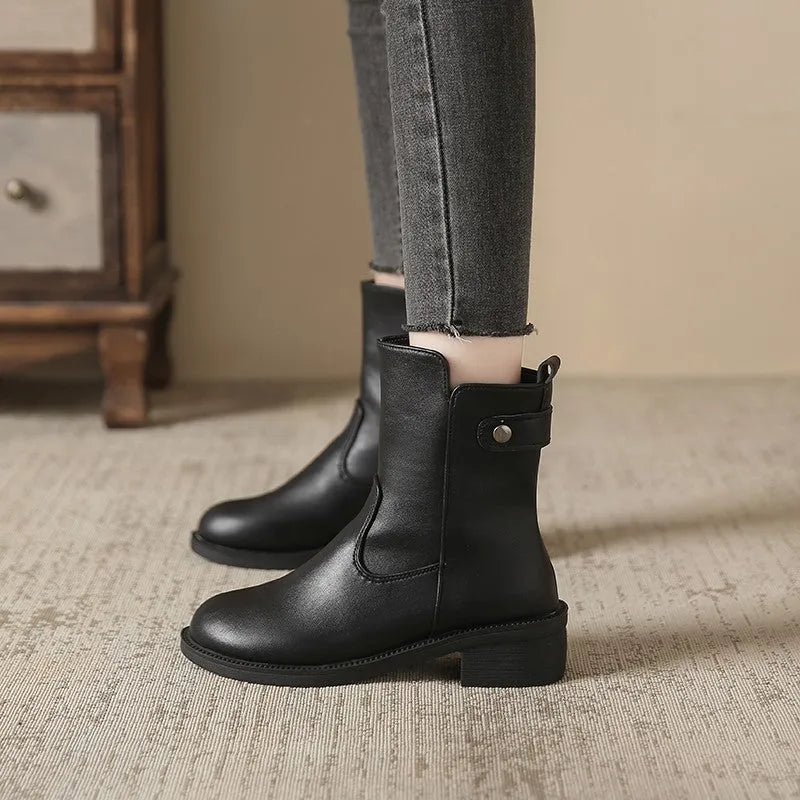 Black women's short boots with a side zip, round toe, and low rubber heel on a neutral background.