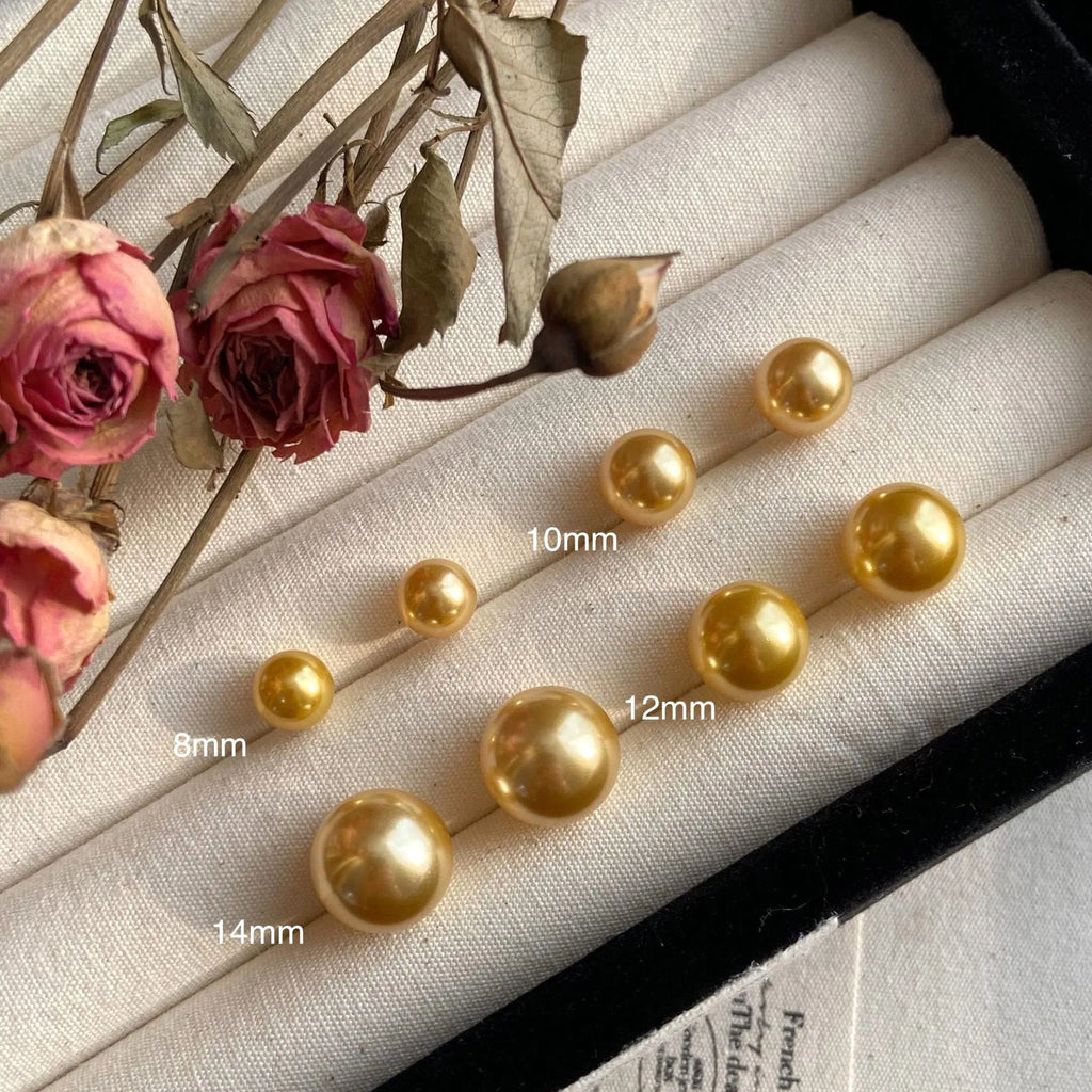 Large geometric pearl stud earrings with an Awn star setting in silver, shown in different size options.