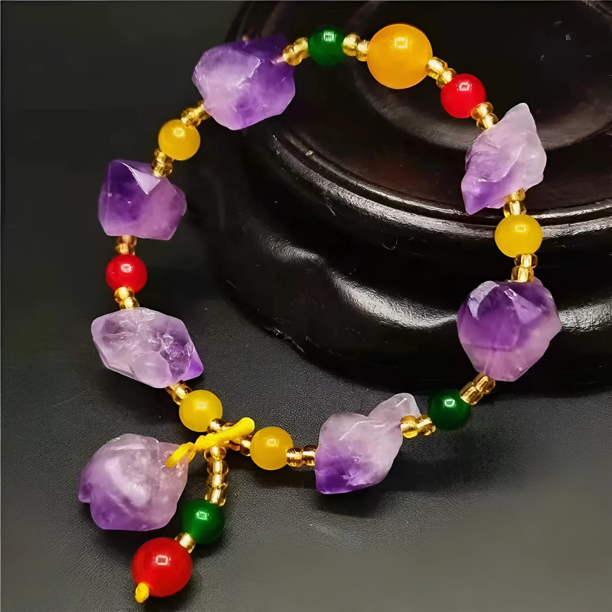 Natural shaped purple amethyst bead bracelet with a silver fu charm on an adjustable knotted cord.