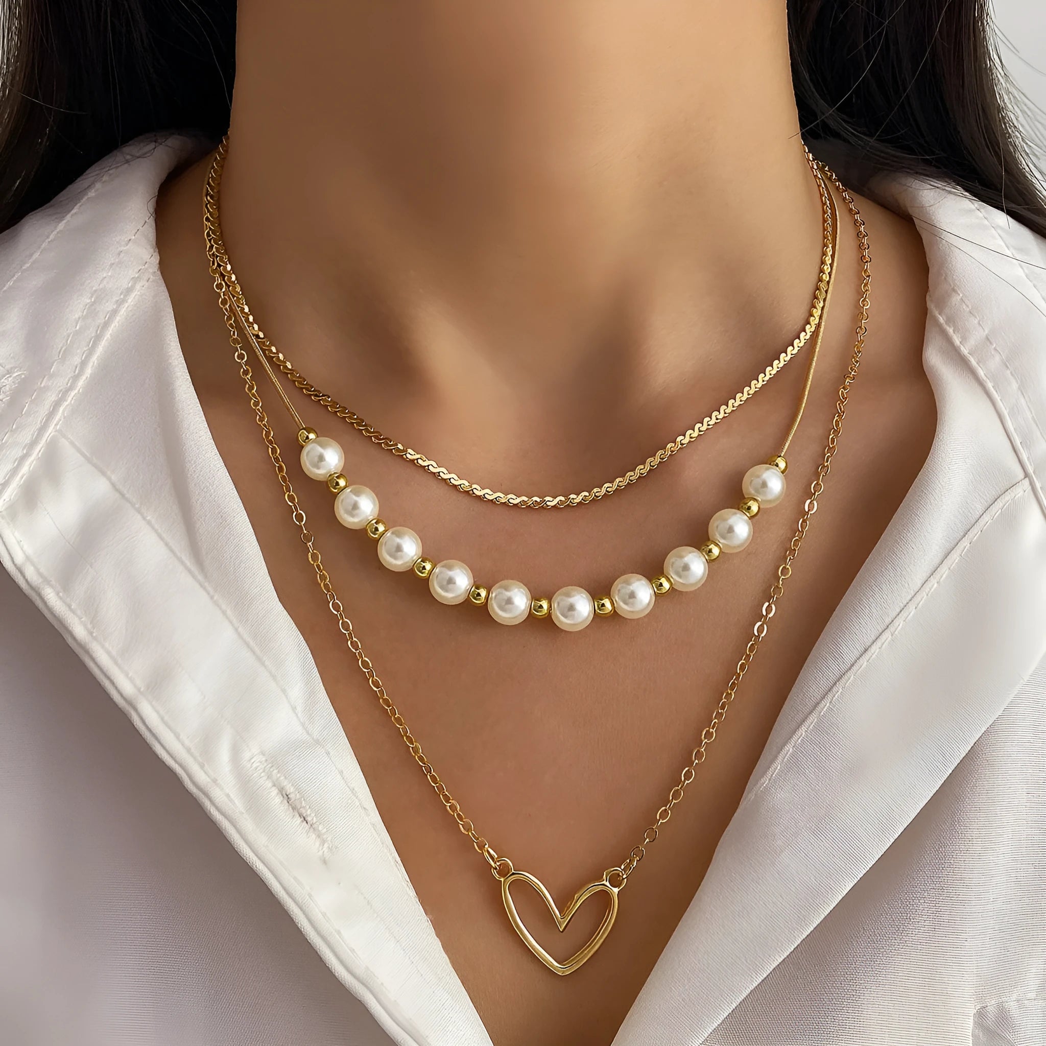 Vintage love heart pearl gold necklace with electroplated alloy pendant and adjustable pearl chain on a white background