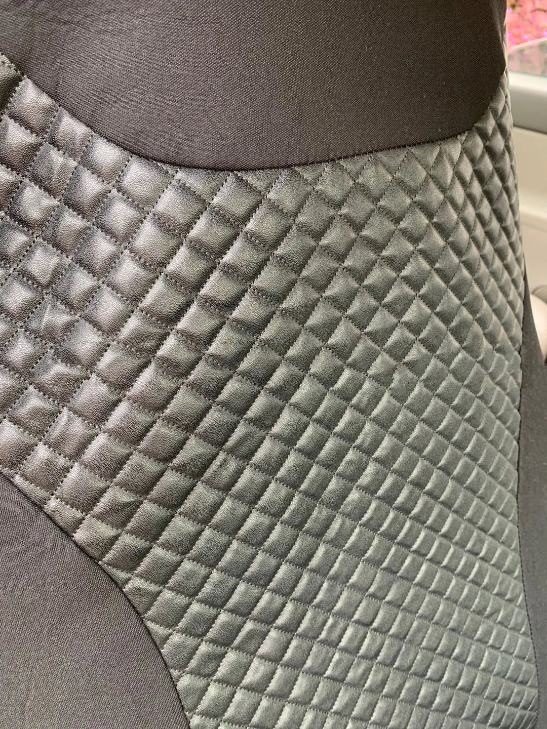Black quilted automotive seat cover with plastic hook fasteners