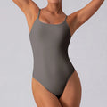 Slim grey sleeveless yoga jumpsuit for women on a mannequin, showing tight fit and triangle neckline