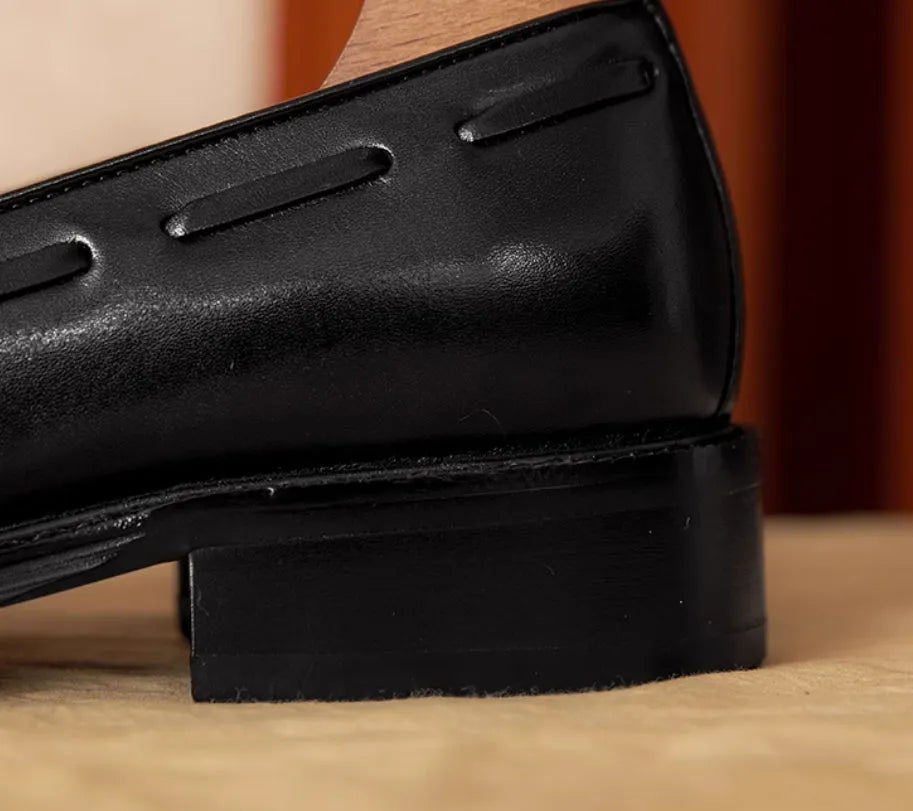 Men's black genuine leather loafers with fringe detailing and slip-on design