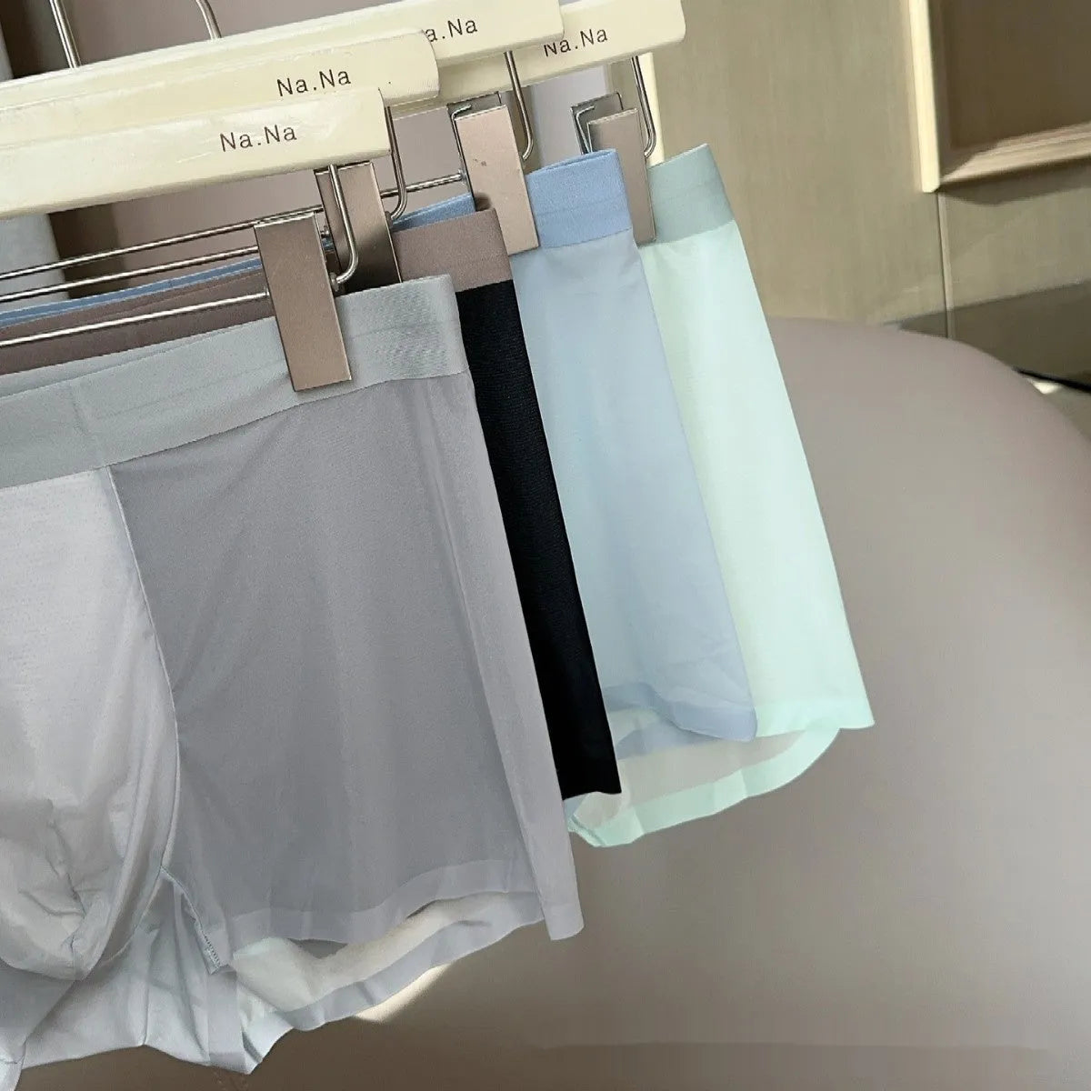 Seamless men's boxers in black showing ultra-thin fabric and mid-waist design.