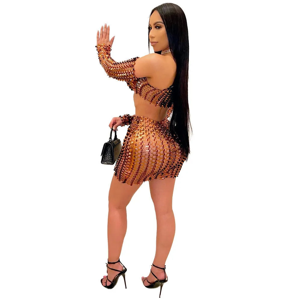 Women's black two-piece dress set with sleeveless hollow-out net top and matching short skirt.