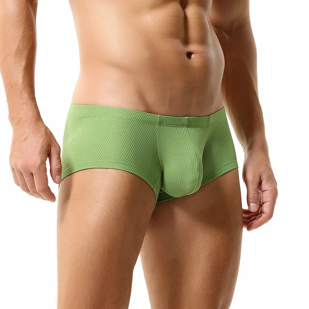 Men's mid-low waist breathable nylon boxer shorts in solid colour orange, front view on white background