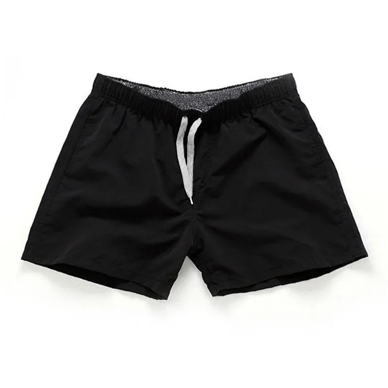 Men's polyester straight-leg surf shorts on a hanger, available in multiple solid colours.