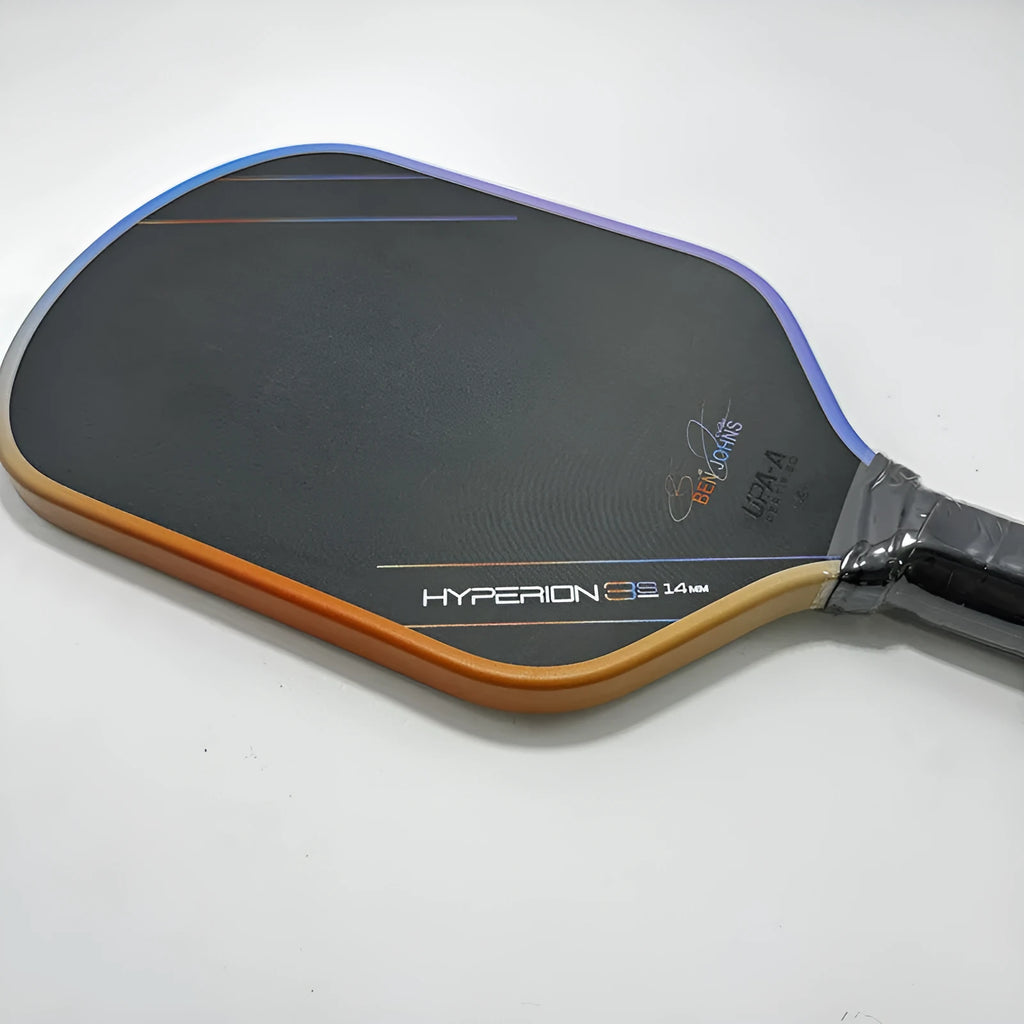 Multicolour matte-finish pickleball racket showing carbon fibre texture and honeycomb core construction.