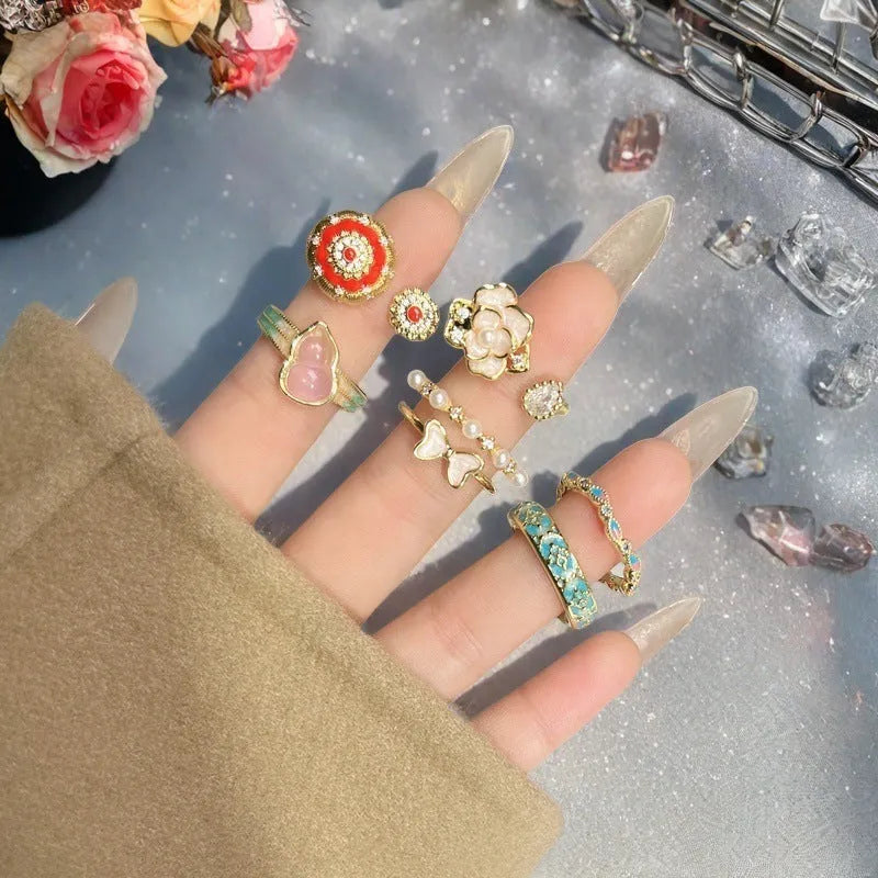 Copper adjustable ring with gourd motif, flower and bow shape, inlaid zircon, and vintage oil drip finish.