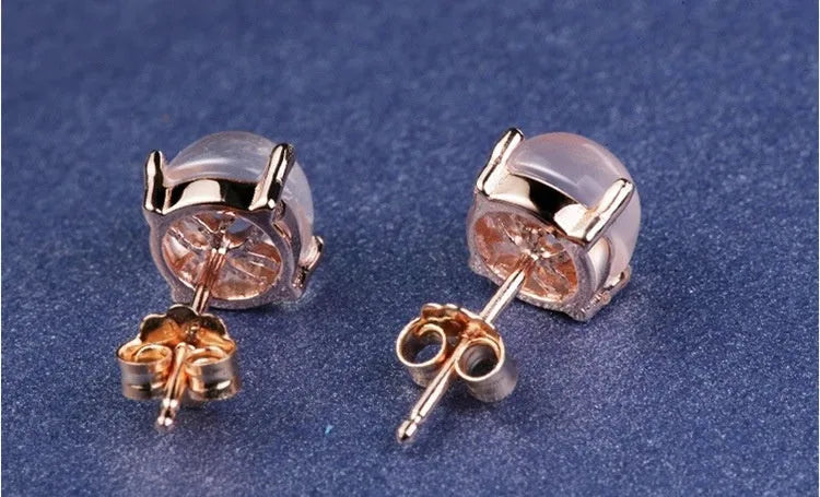 Rose gold coloured drop shaped stud earrings for women with a synthetic quartz stone.