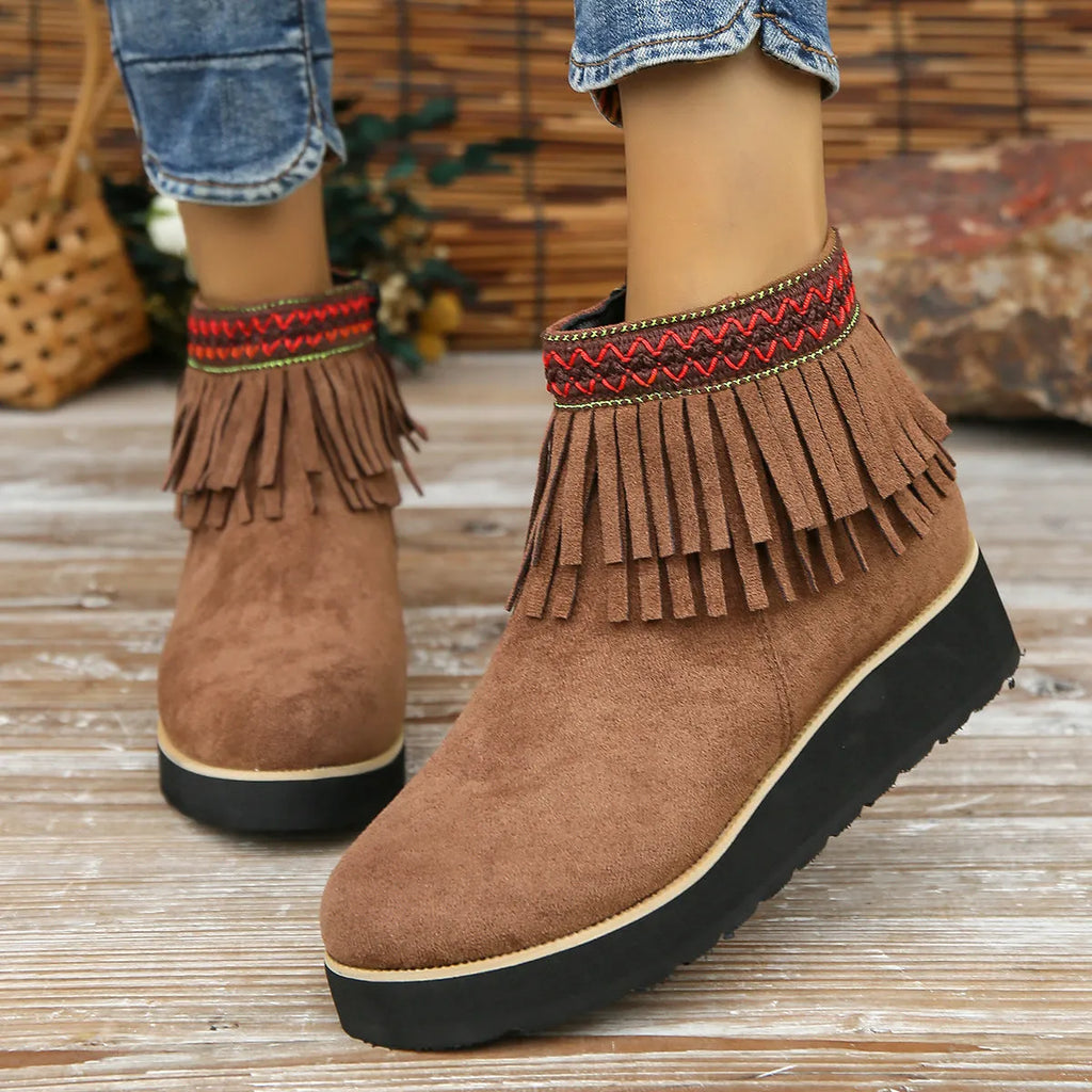 Women's suede wedge ankle boots in dark brown with a side zipper and tassel detail.