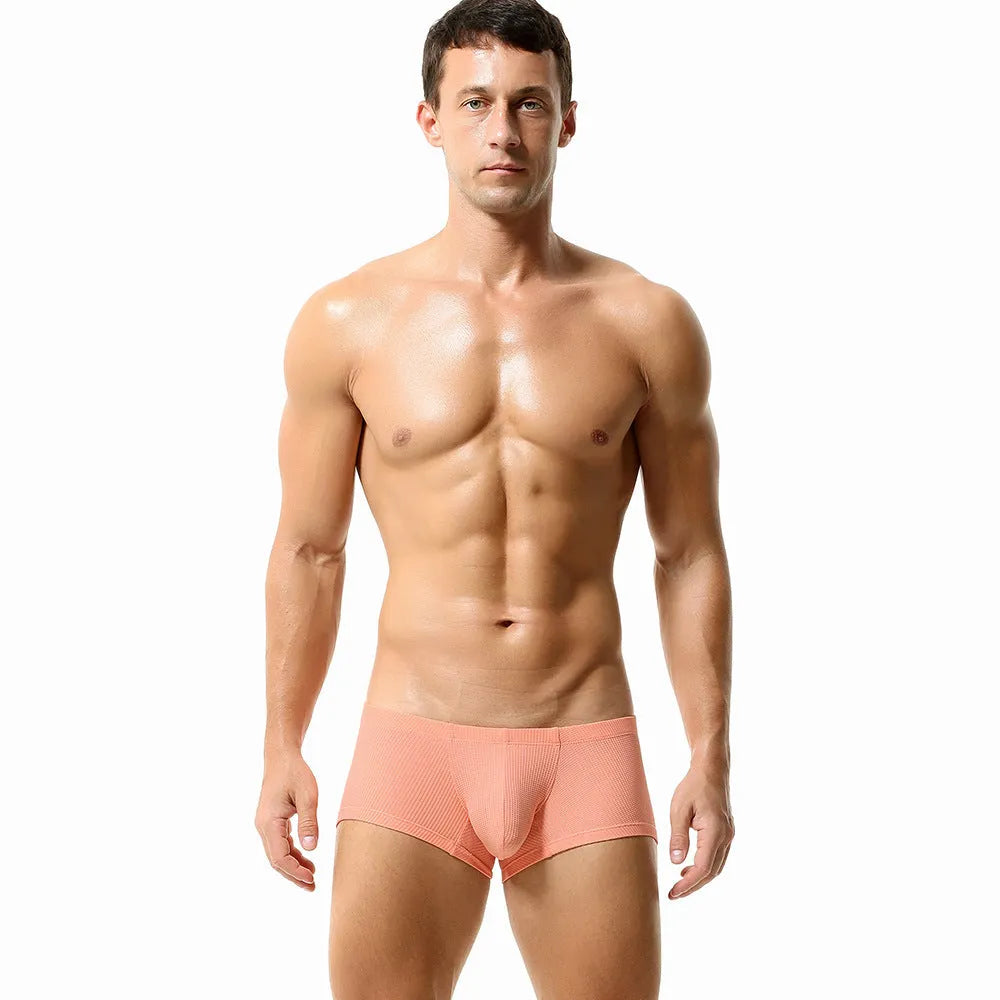 Men's mid-low waist breathable nylon boxer shorts in solid colour orange, front view on white background