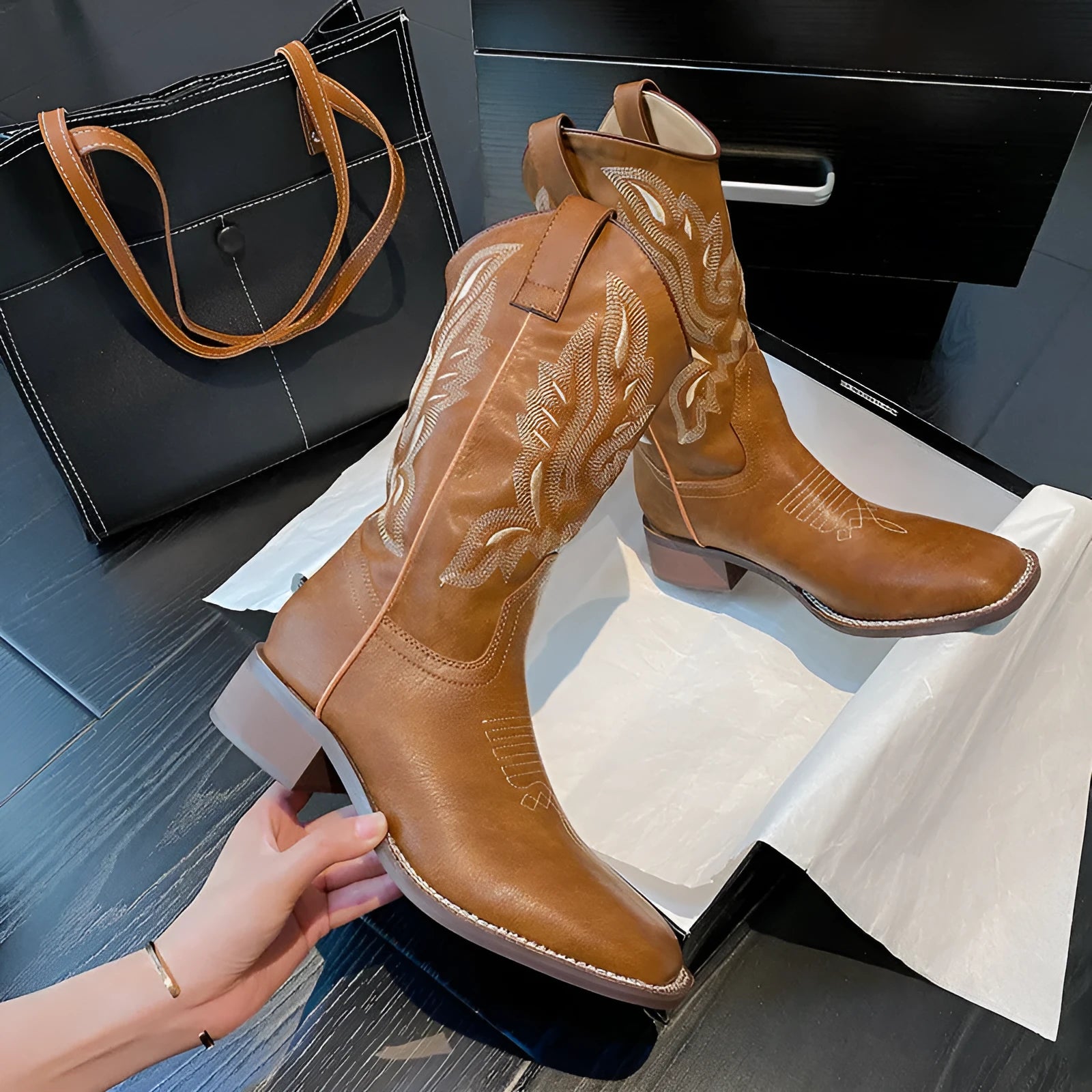 Brown women's mid-calf Martin boots with embroidered pattern, leather lining, and a lace-up front.
