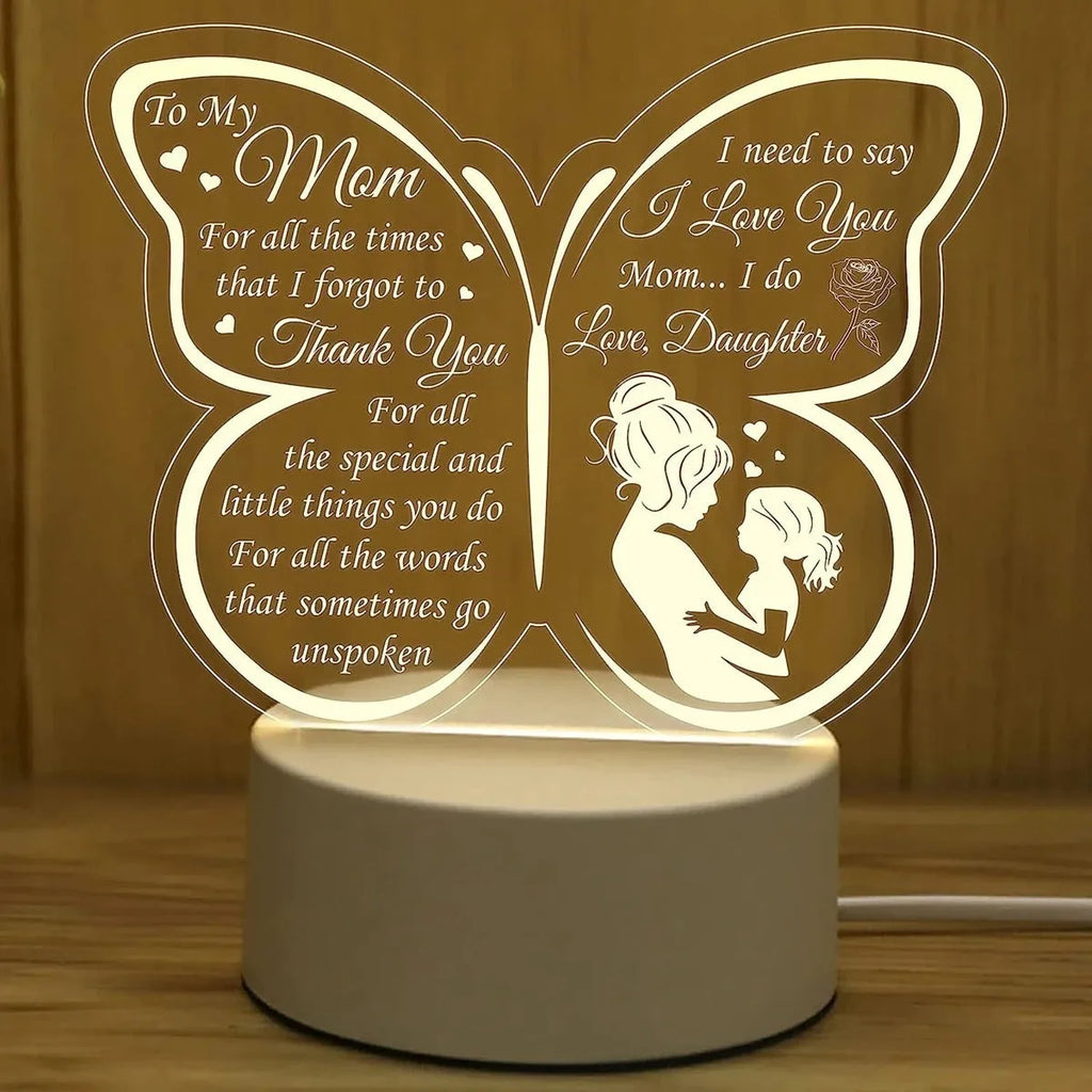 White heart-shaped acrylic table lamp with USB cable and touch-sensitive base on a wooden desk.