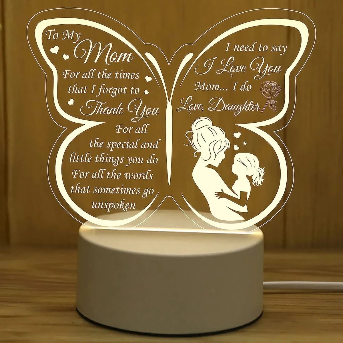White heart-shaped acrylic table lamp with USB cable and touch-sensitive base on a wooden desk.