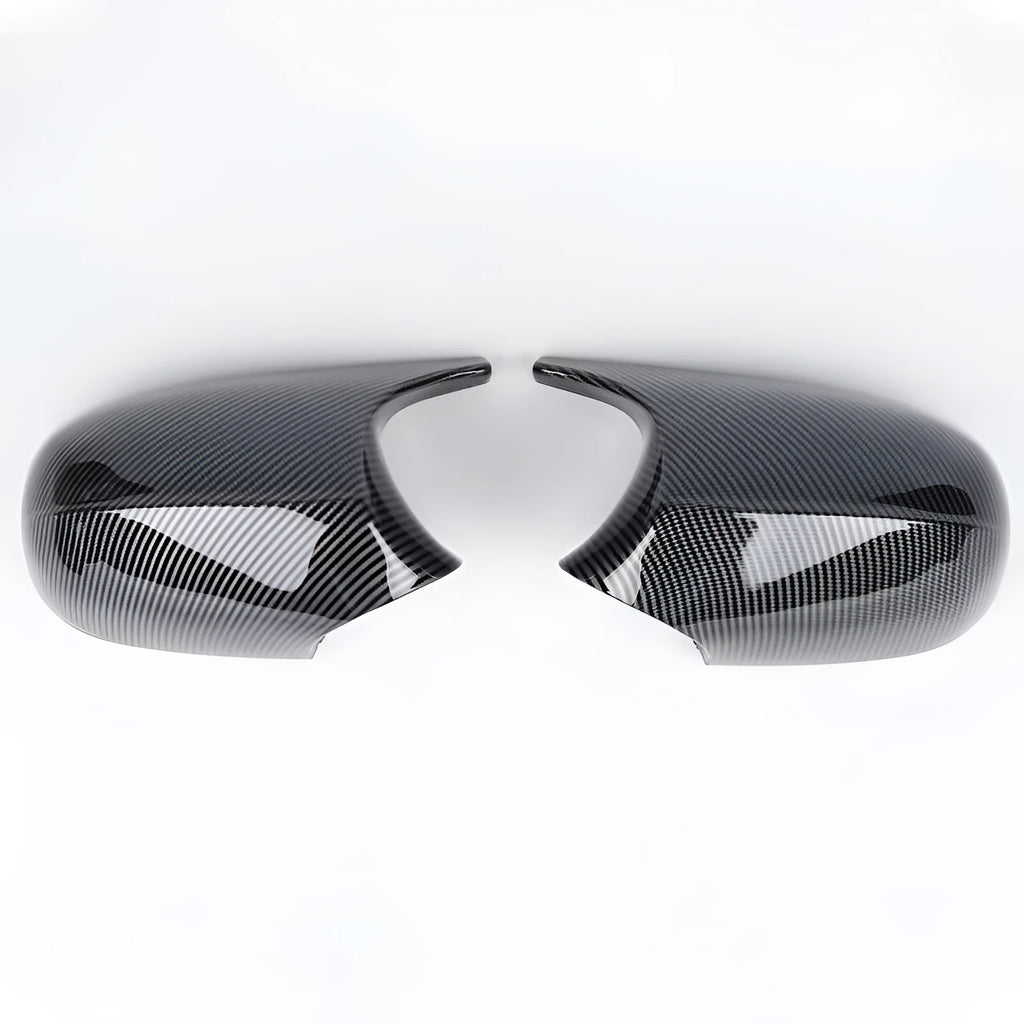 A pair of black and carbon pattern ABS plastic rearview mirror housing shells for a BMW 3 Series E90.