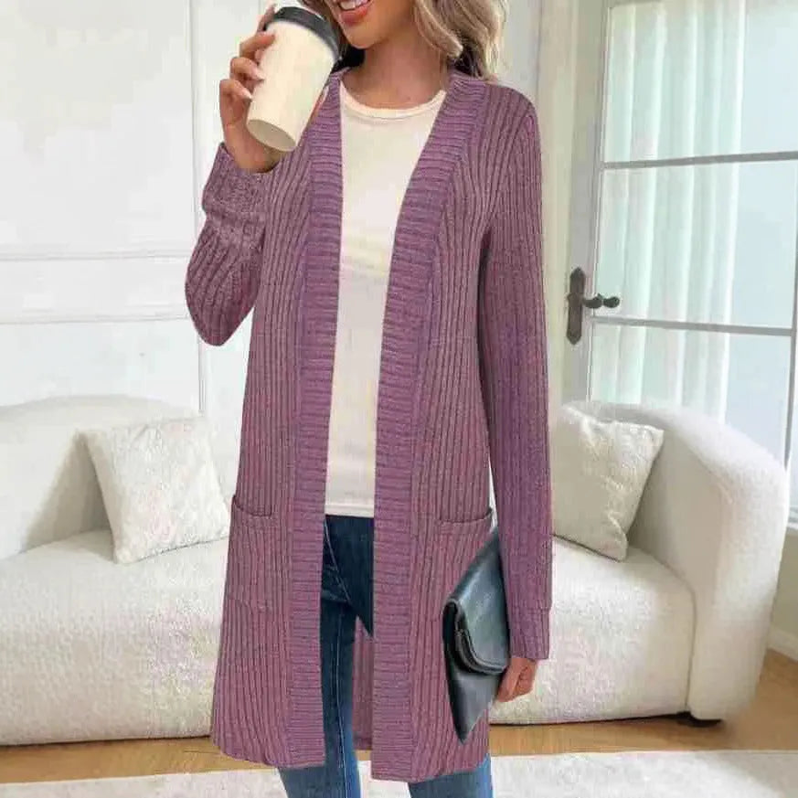 Black oversized knitted cardigan jacket with long sleeves and loose pockets.