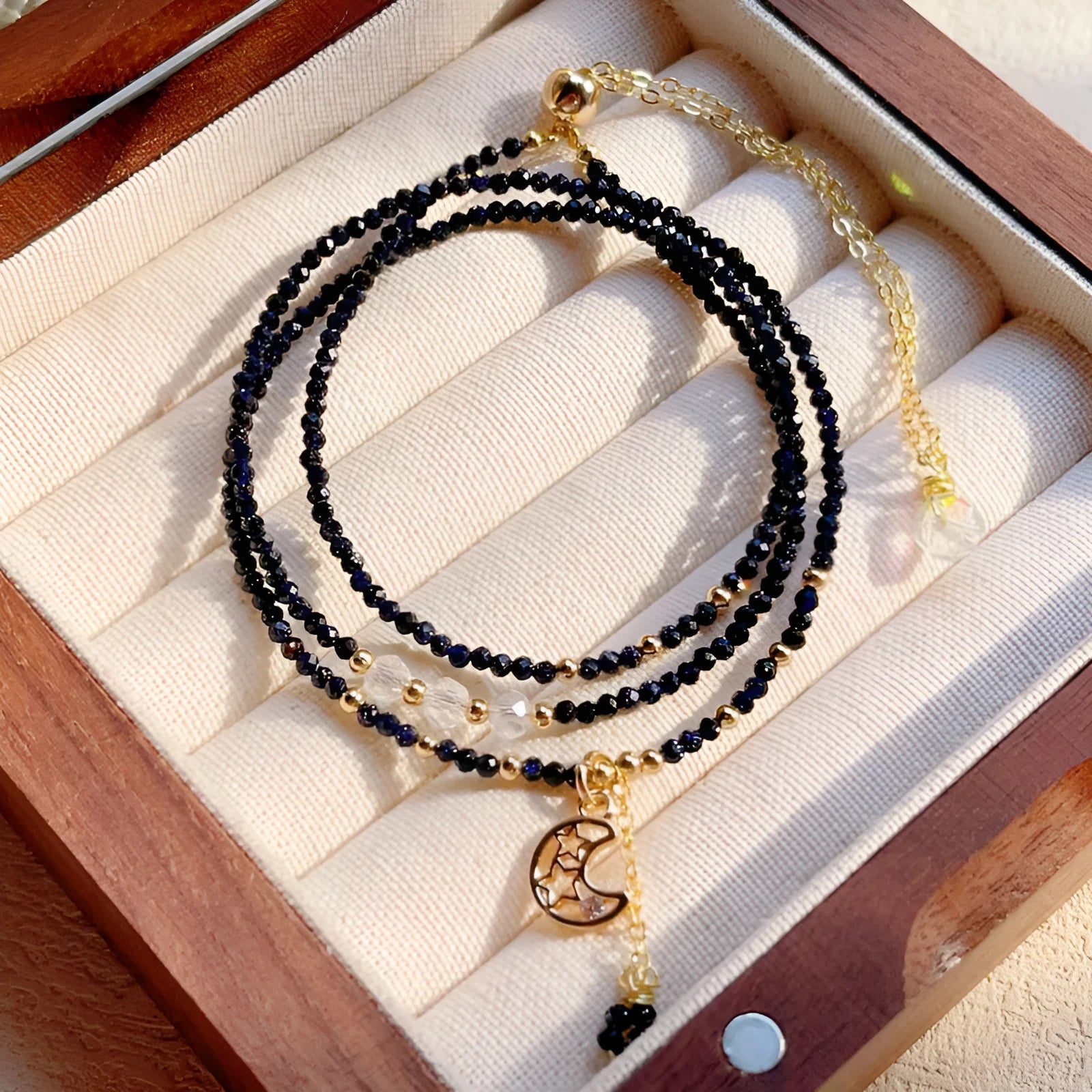 Blue and gold three-ring women's bracelet with sand stone cut beads showing manual processing texture details