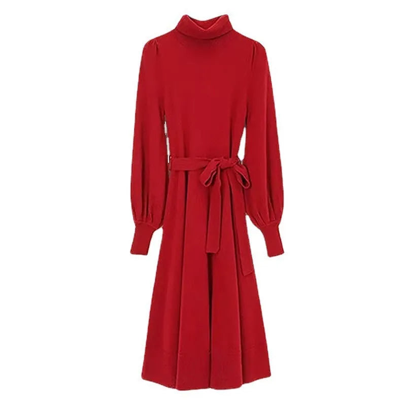 A woman wearing a rose red turtleneck long-sleeve knit dress with an elastic waist and loose hem.
