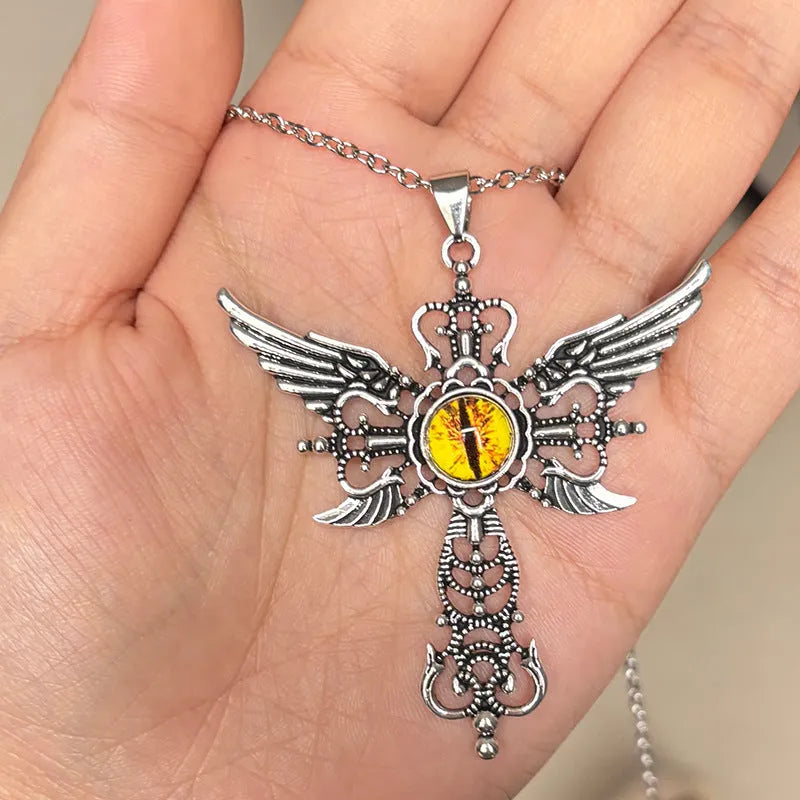 Close-up of a blue alloy necklace featuring a geometric cross pendant with detailed devil wings.