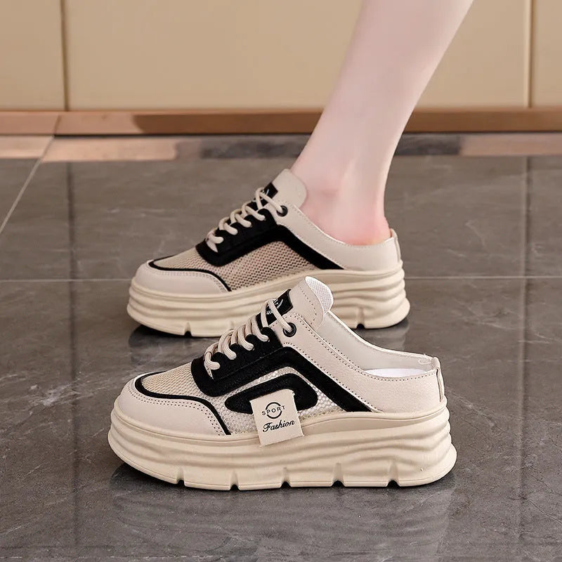 Women's black mesh half slippers with round toe and rubber sole, shown on a foot.