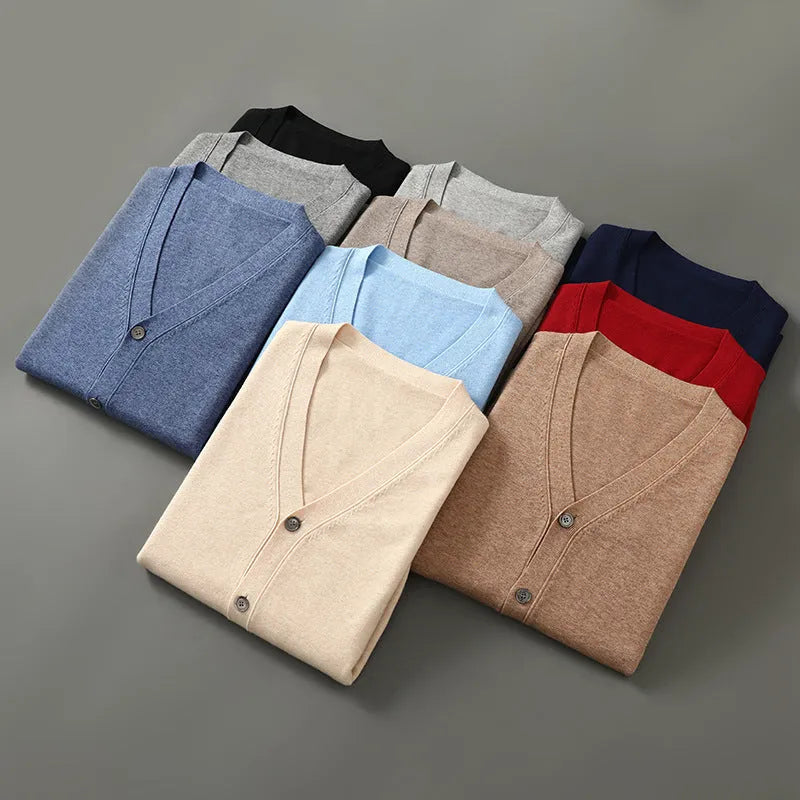 Man wearing a beige loose-fit V-neck Andy velvet knitted cardigan coat with long sleeves.