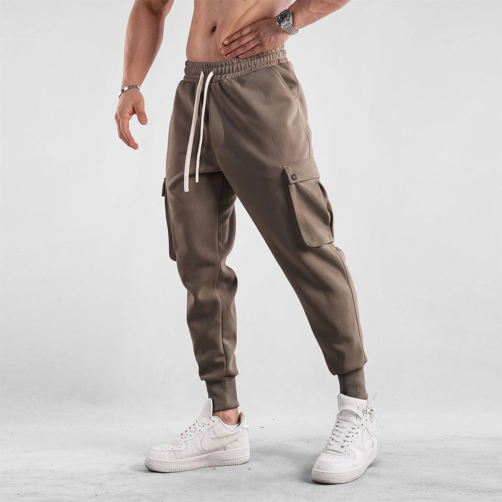 Men's loose fit American sports trousers with ankle ties in apricot colour showing multi-pocket design