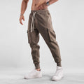 Men's loose fit American sports trousers with ankle ties in apricot colour showing multi-pocket design