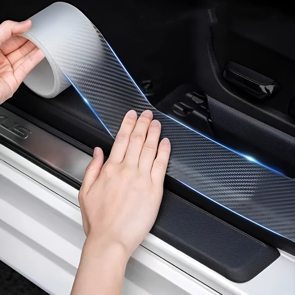 Roll of carbon fibre car door edge protection strip in clear carbon grain finish with scraper and utility knife