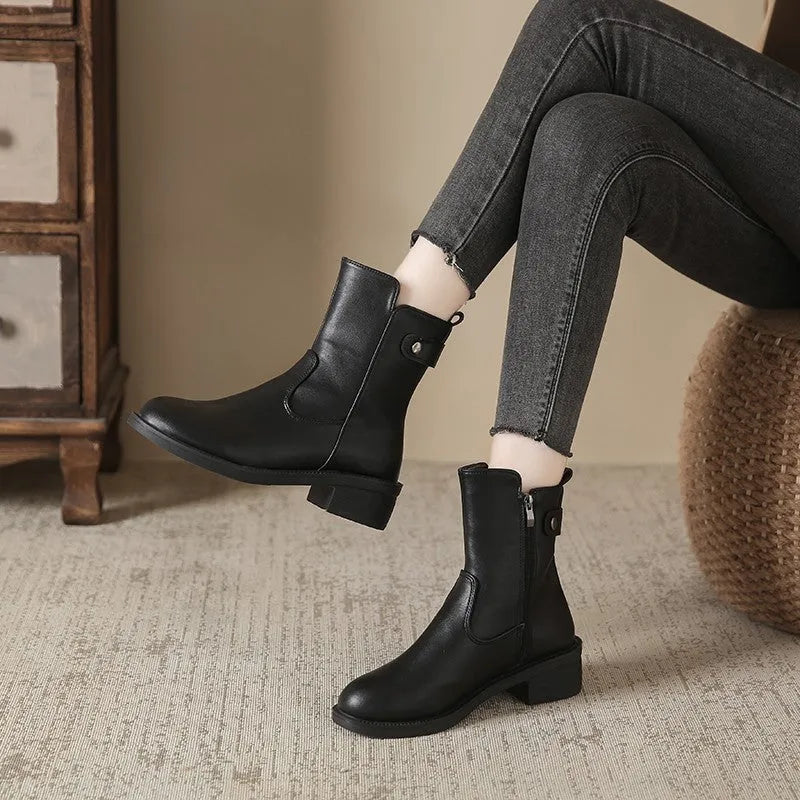 Black women's short boots with a side zip, round toe, and low rubber heel on a neutral background.