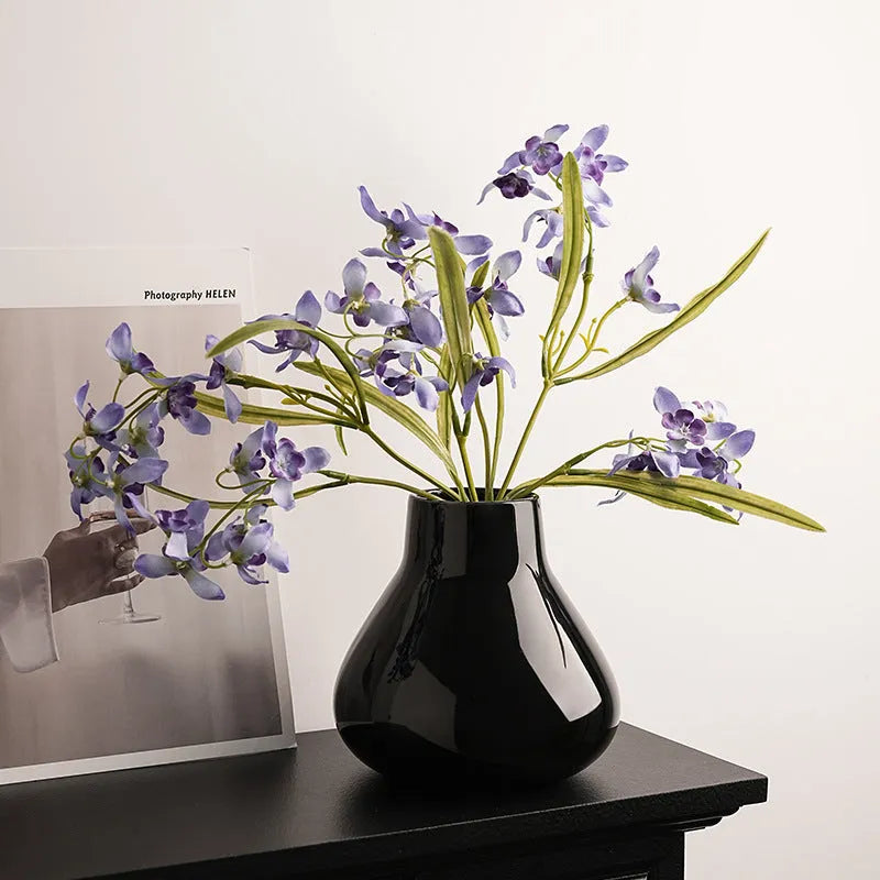 Ceramic decorative vase set with artificial orchid flowers in black or white coloured glaze finish