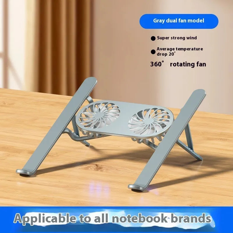 Silver aluminium laptop stand with twin cooling fans in folded position beside notebook computer