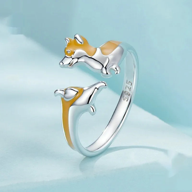 Silver ring with a raised cartoon corgi dog design and electroplated colour finish.